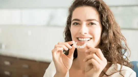 woman holding clear veener