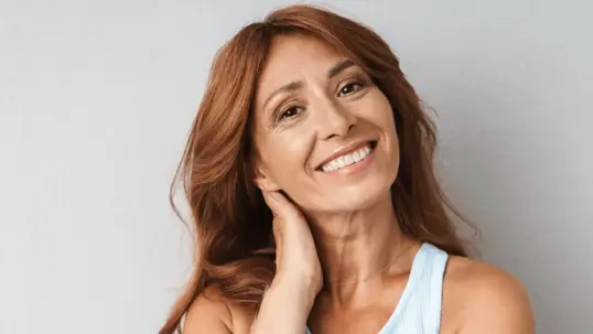 Smiling woman with long, auburn hair