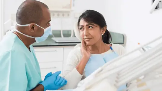 A woman is seated in a dental chair