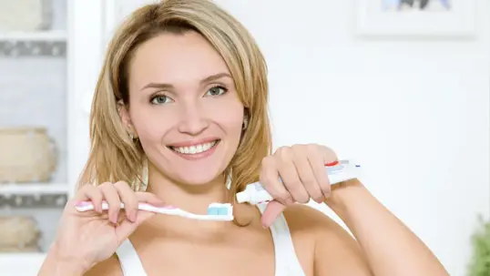 woman preparing to brush her teeth