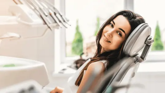 woman sitting in a dental chair.